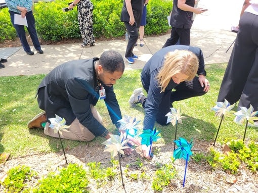FMOL Health | St. Dominic plants pinwheels for April’s Child Abuse Prevention Month